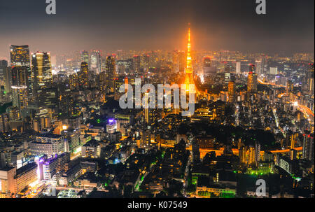 Aerial view of Tokyo with Tokyo Tower at night. Tokyo mixes the ultramodern and the traditional, from neon-lit skyscrapers to historic temples. Stock Photo