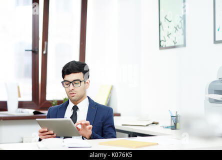 Young Manager Wrapped up in Work Stock Photo