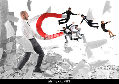 Businessman attracts people with a big magnet Stock Photo