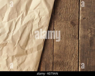 Crumpled paper on an old wooden table using as natural background with space for text or image Stock Photo