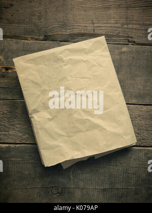 Crumpled paper on an old wooden table using as natural background with space for text or image Stock Photo