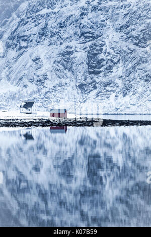 Perfect reflection of mountains and red house, Lofoten Islands, Norway Stock Photo