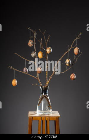 Vase with tree branches and multicolored hand painted easter eggs Stock Photo