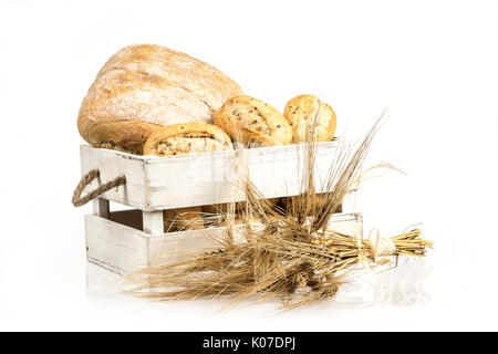 Buns and ciabatta, bread on wooden box. Barley and fresh mixed breads isolated on white background. Food, bakery concept Stock Photo