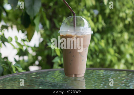 Premium Photo  Iced latte coffee in takeaway glass on table in