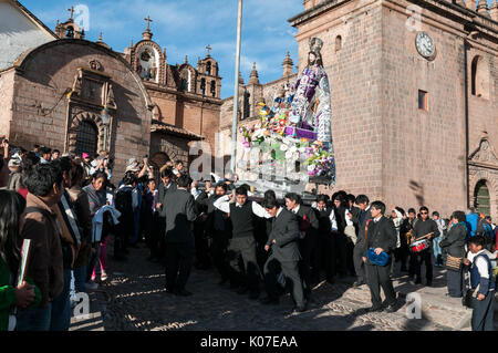 Parishioners carry a large statue of Saint Joseph on a pedestal from Cusco Cathedral during celebrations of Corpus Christi, Cusco, Peru. Stock Photo