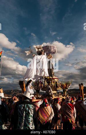 Parishioners dressed in Quechua clothing carry a statue of Nativity of Virgin Mary during Corpus Christi festival in Plaza de Armas, Cusco, Peru. Stock Photo