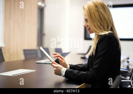 Portrait of beautiful blonde businesswoman holding tablet Stock Photo