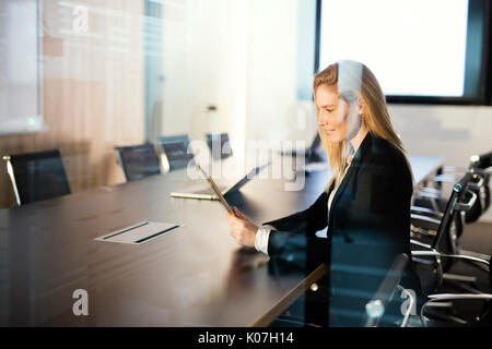 Portrait of beautiful blonde businesswoman holding tablet Stock Photo