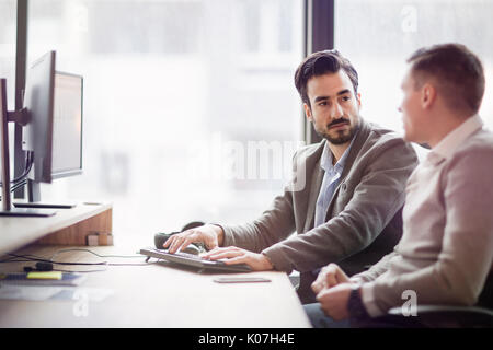 Picture of two young businessmen having discussion Stock Photo