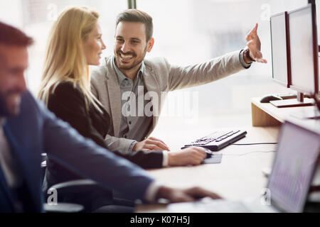 Portrait of cheerful business couple working on computer Stock Photo