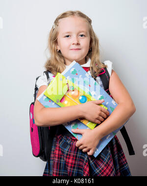 child in a school uniform with a backpack Stock Photo