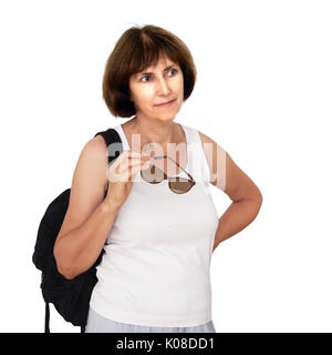 Mature tourist on white background. Unbranded clothes, sunglasses. Stock Photo