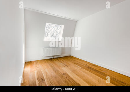 Empty Domestic Room with Hardwood Floor, Radiator and Window Stock Photo