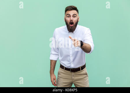 Wow that's great! Portrait of young adult with beard with shocked facial expression. Indoor, studio shot Stock Photo