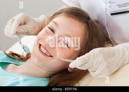 Portrait of happy girl undergoing dental treatment at clinic Stock Photo