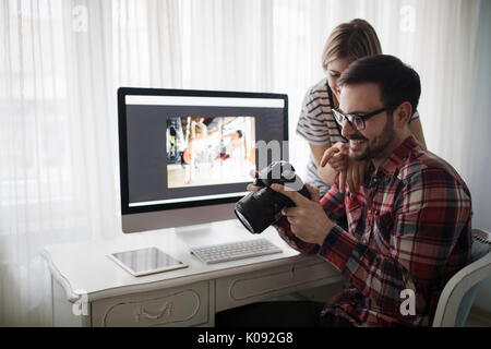 Beautiful woman and attractive man doing design work Stock Photo