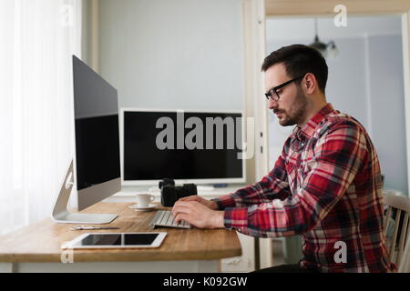Portrait of young attractive man doing design work Stock Photo
