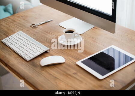 Picture of computer, scissors and camera on working desk Stock Photo