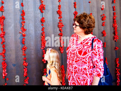 Grandmother and granddaughter examine Roll of Honour at Australian War Memorial in Canberra, Australia's national capital Stock Photo