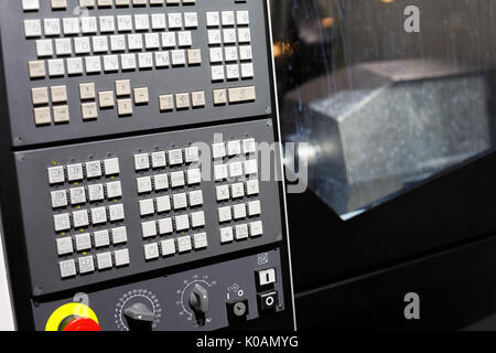 CNC machining center with control panel on the foreground. Selective focus. Stock Photo