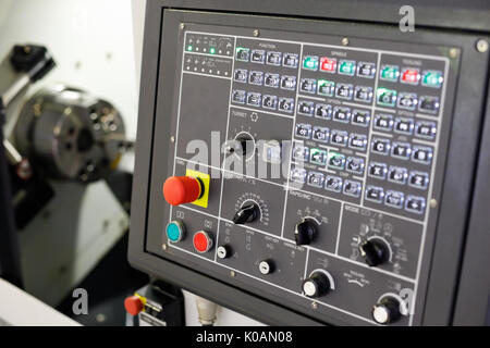 Closeup of modern cnc turning centre with control panel on the foreground. Selective focus. Stock Photo