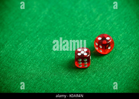 Red poker dices on casino table background Stock Photo