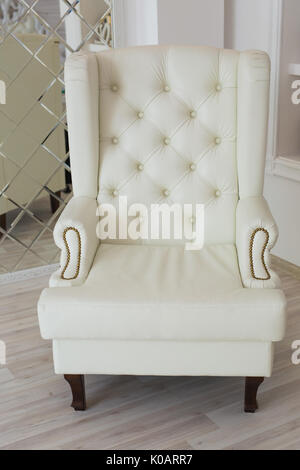 luxury armchair in a plain white interior Stock Photo - Alamy