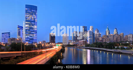 Philadelphia skyline illuminated and reflected into Schuylkill River at dusk, USA Stock Photo