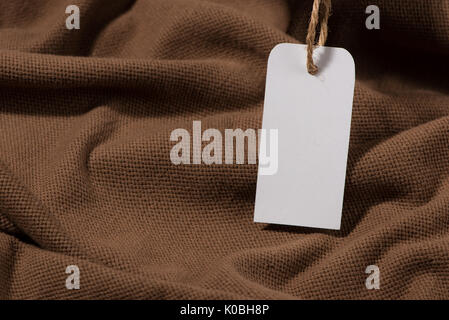 Shirt price tag. Rectangular tag is attached to a sweater Stock Photo