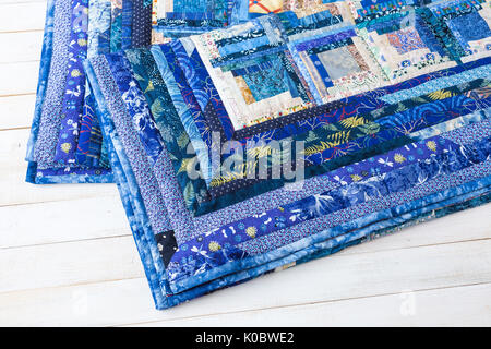 decoration, comfort, passion, fondness, stitching, patchwork concept - two dark blue quilt neatly maded of different patches with interesting floral pattern and almost invisible stitches Stock Photo