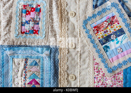 handmade, fashion, accessories concept -flatlay of charming women's bag made of velveteen and front part sewing in technique patchwork with colorful ornate snippets. it has two straps, lace and button Stock Photo