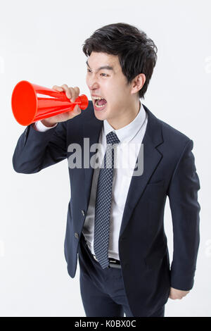 High angle view of young businessman yelling through a megaphone Stock Photo