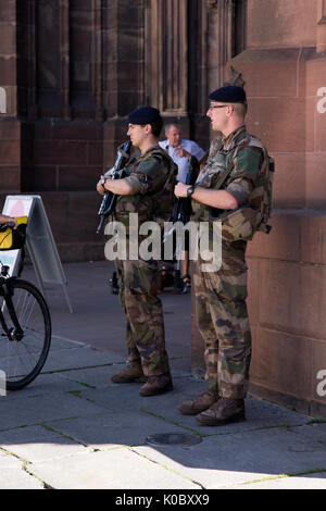 Two heavily armed French soldiers on duty outside Strasbourg Cathedral or the Cathedral of Our Lady of Strasbourg. Stock Photo