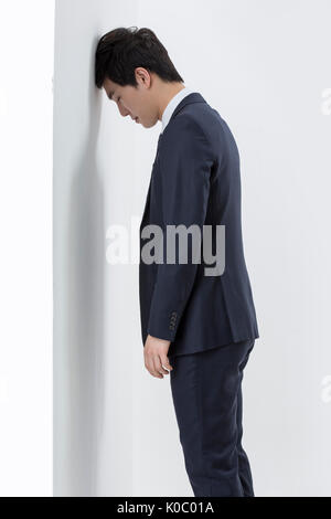 Side view of young businessman in suit worried standing Stock Photo