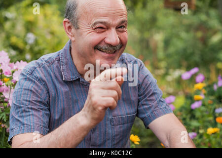 Smiling attractive senior man looking directly at the camera and laughing Stock Photo