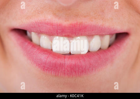 Cropped image of young woman with toothy smile Stock Photo