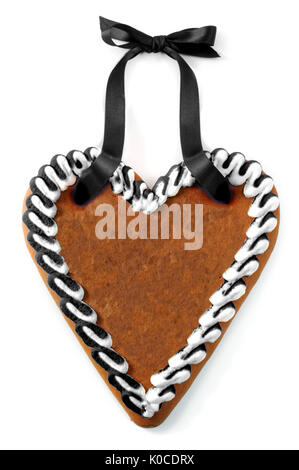 black gingerbread heart cookie on white isolated background with copy space. sadness concept. Stock Photo