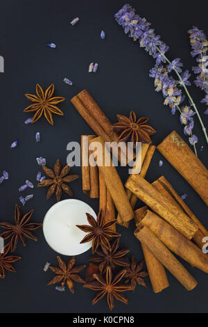 Sense of Spices cinnamon and star anise whit candle on black background with copy space Stock Photo