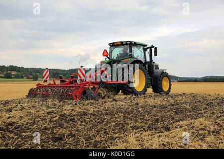 SALO, FINLAND - AUGUST 18, 2017: Farmer works with John Deere 6155R tractor and Horsch Terrano 3FX cultivator on Puontin Peltopaivat 2017 Agricultural Stock Photo