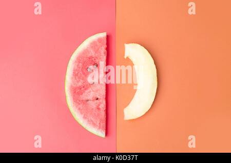 Slice of watermelon with stones on red background and melon isolated over orange background Stock Photo