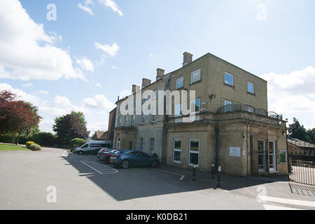 Spratton public School Northamptonshire UK boys boy girl girls playing play work building gate gates minibus cars teacher teachers metal door gated UK Stock Photo