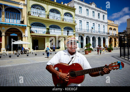Capital Havana in Cuba, Cuban guitar busker performs for tips  Old Square in the Old Town Stock Photo