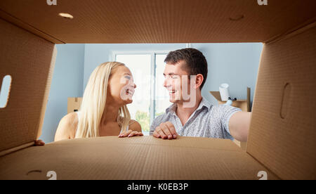 A young couple unpacks boxes.  Stock Photo