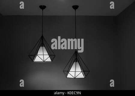 Two pendant lamps hanging on ceiling. Contemporary Design in black and white shade. Stock Photo