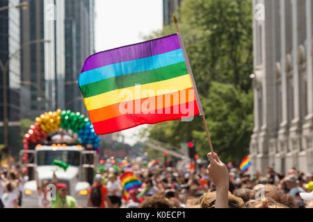 Montreal, CANADA - 20 August 2017: Gay rainbow flag at Montreal gay pride parade with blurred participants in the background Stock Photo