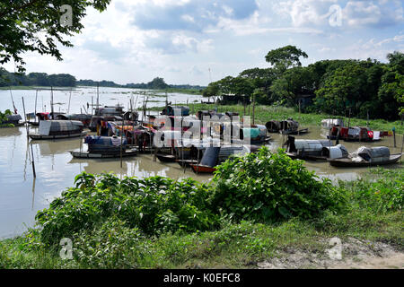 DHAKA, BANGLADESH – AUGUST 19, 2017: A bunch of narrow boats floating on water belonging to gypsies moored at Nawabganj in Dhaka, Bangladesh. The Bede Stock Photo