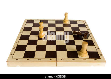 Endgame. The black chess king is defeated and lies on the board. Stock Photo