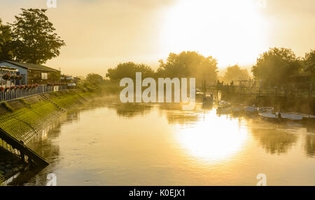 Evaporating steam fog rising over the River Arun on a cold morning in Arundel, West Sussex, England, UK. Stock Photo