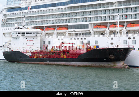 Southampton Docks England UK. August 2017. Bunkering vessel alongside a cruise ship pumping fuel Stock Photo